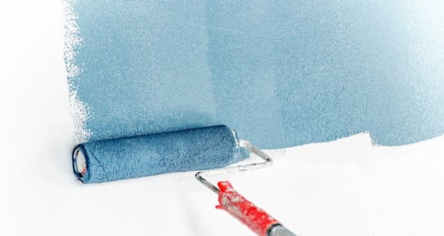 Rolling paint onto a wall during refurbishment